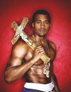 Here's Kayne posing with a giant Catholic crucifix, which represents 666 in Revelation 13:18